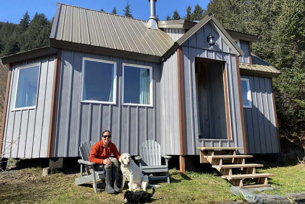 cabin exterior man and dogs