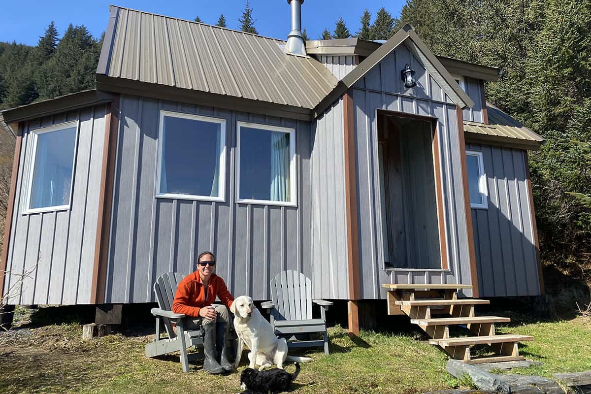 cabin exterior man and dogs