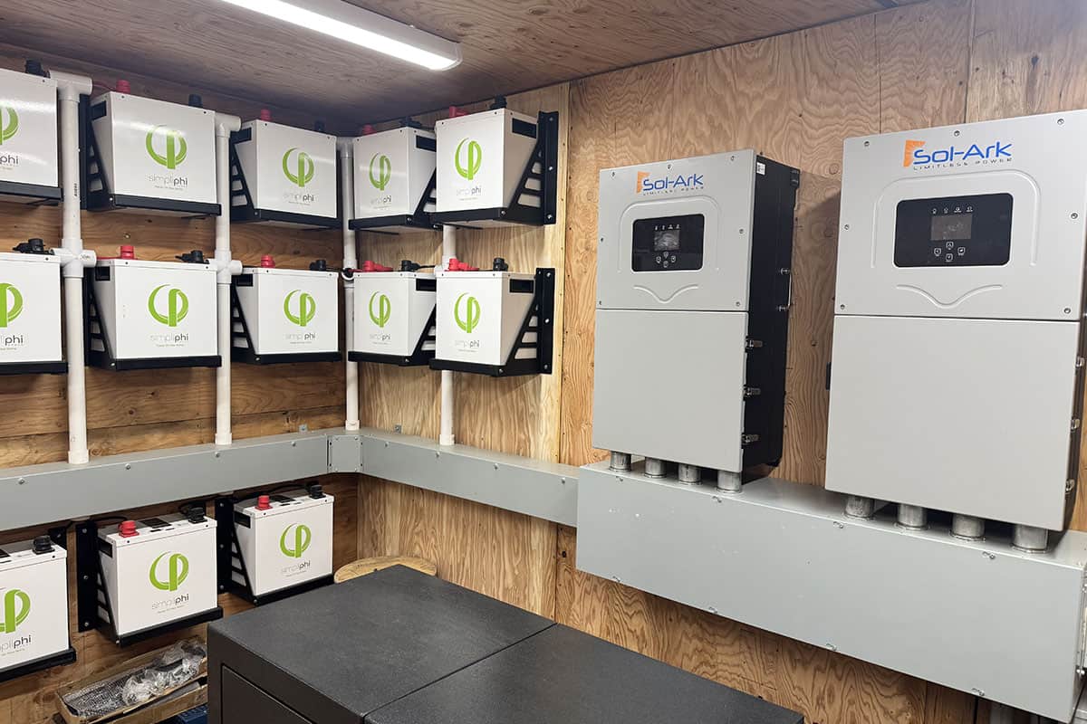 Indoor solar battery storage system with multiple batteries and inverters.